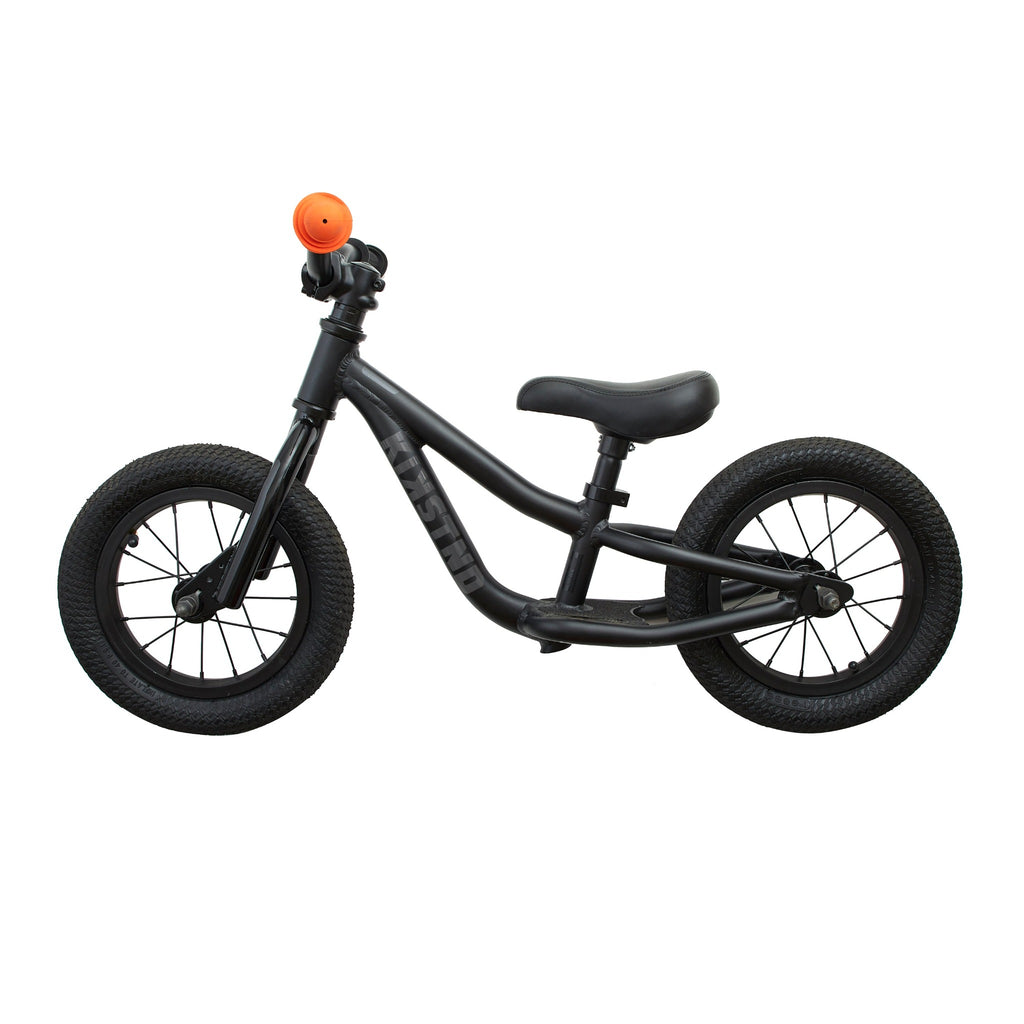 Balance bike for kids. Black balance bike for kids on white background. Side view.