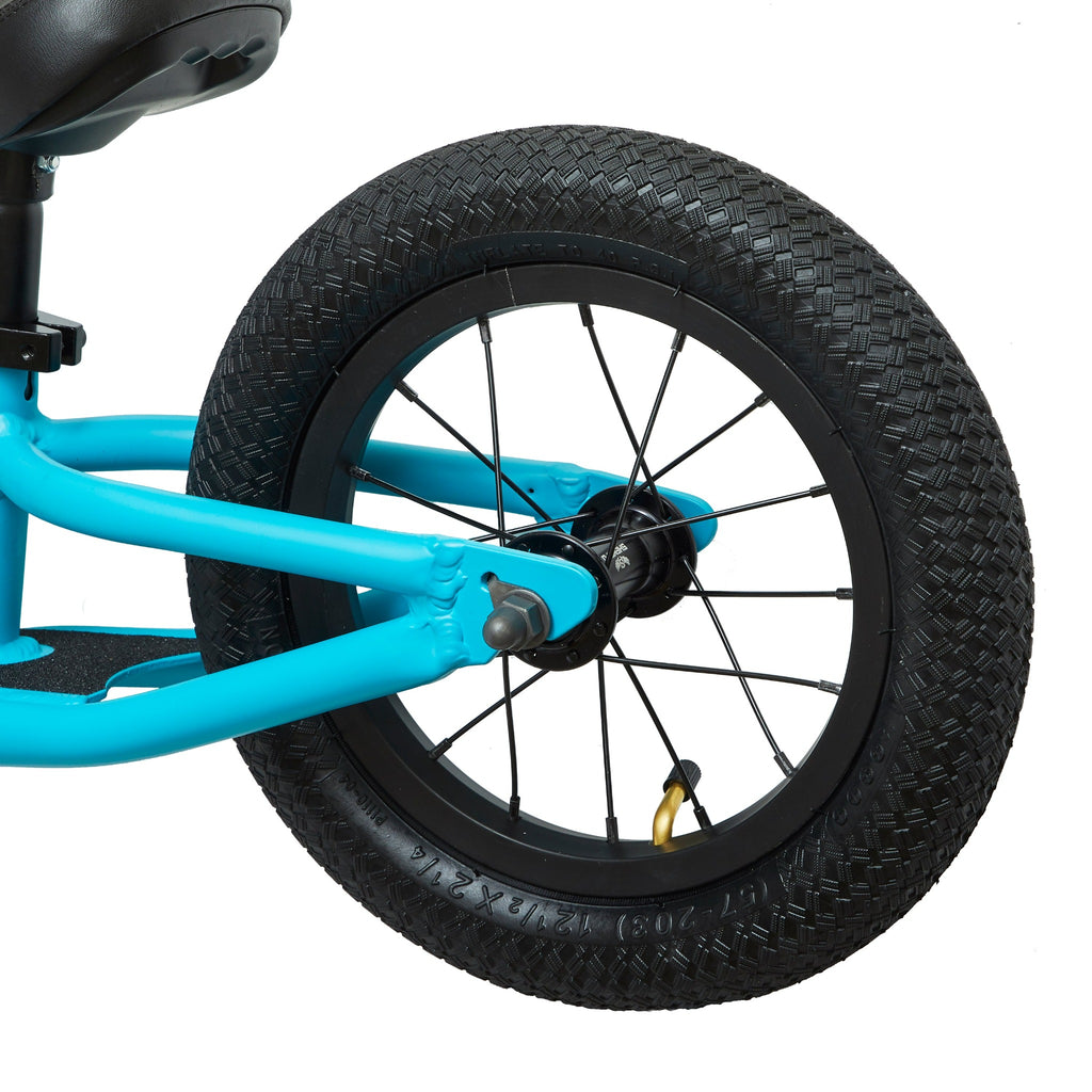 Rear tire of light blue balance bike for kids.