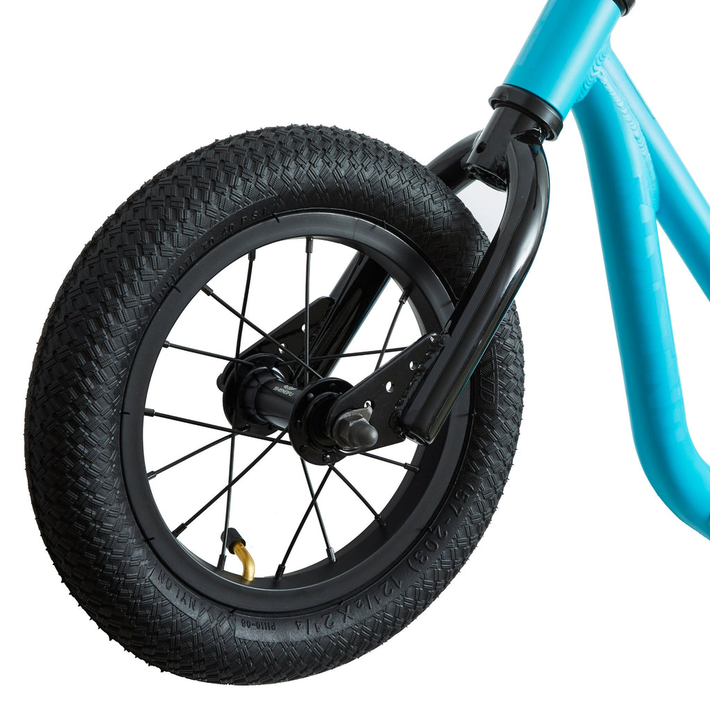 Front wheel of light blue balance bike for kids.