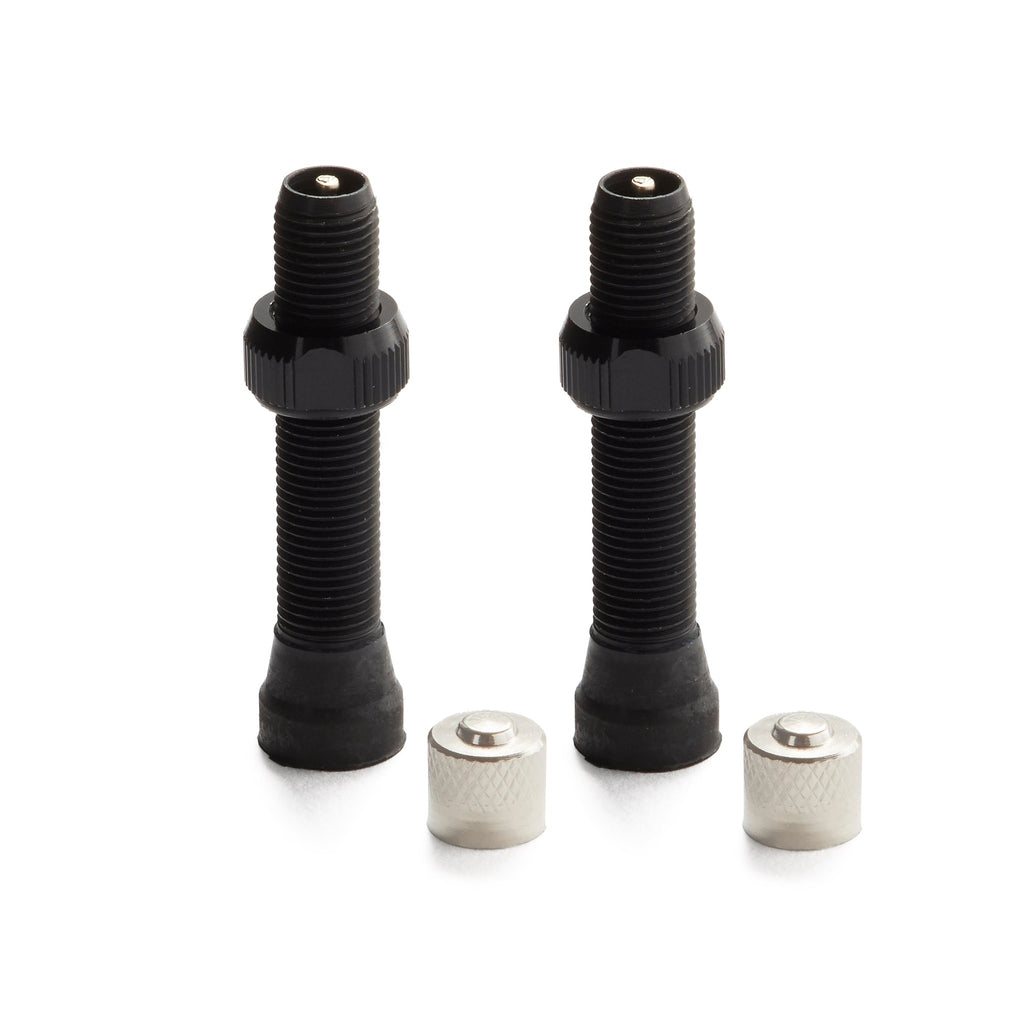 A pair of schrader valve stems in the color black for tubeless mountain bikes. Silver caps.