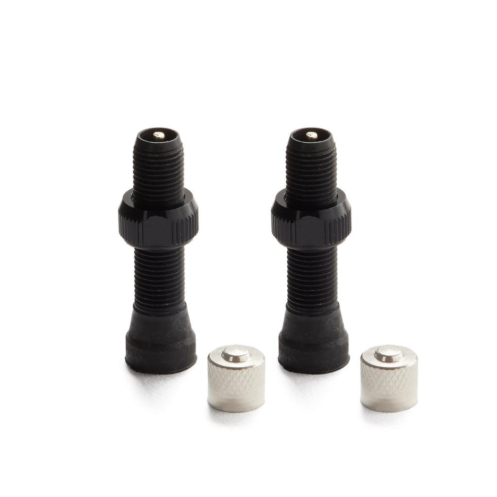 A pair of schrader valve stems in the color black for tubeless mountain bikes