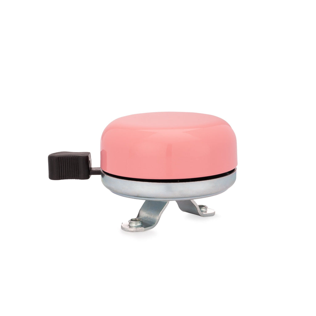 Classic bicycle bell blush pink, side view on white background. Vintage style bicycle bell.