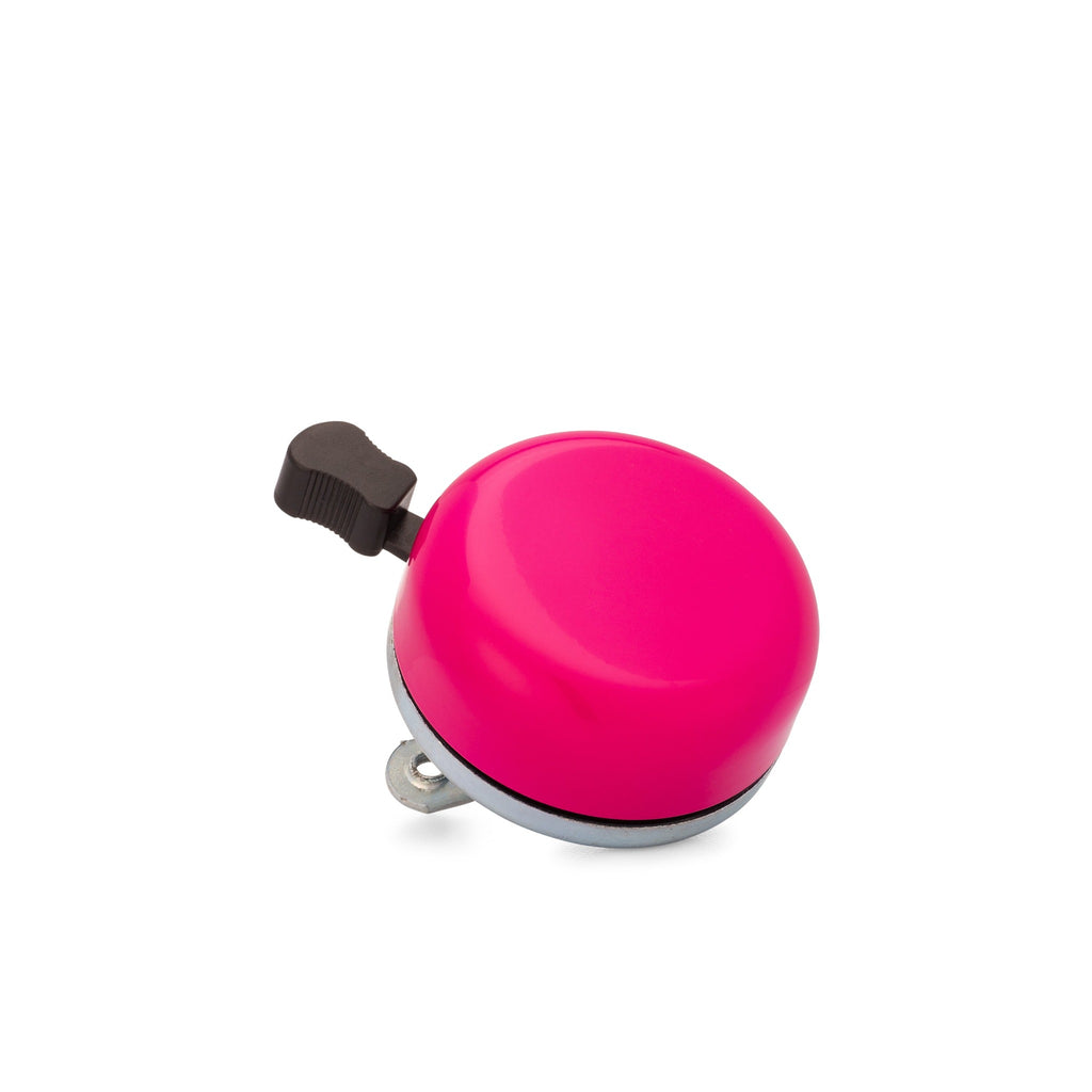 Classic bicycle bell color magenta, corner view on white background. Vintage style bicycle bell.