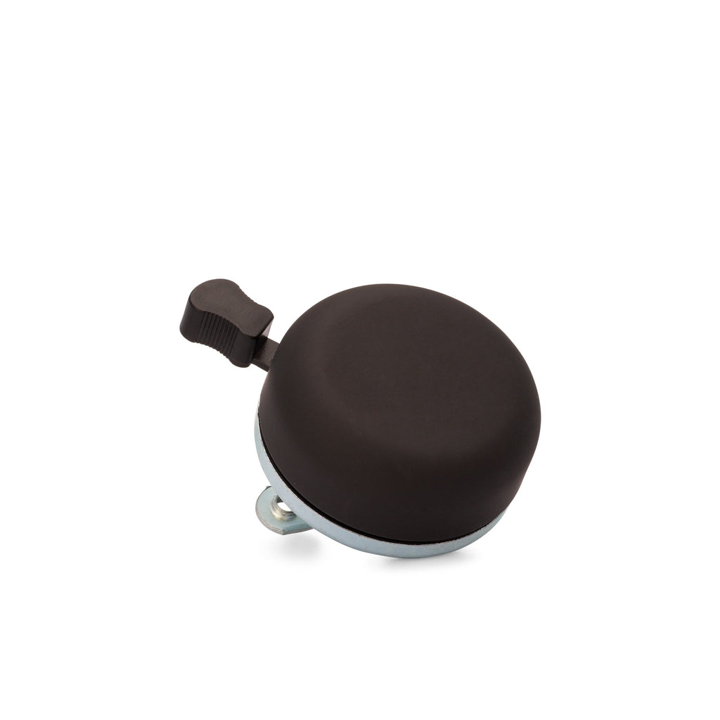 Classic bicycle bell color matte black, corner view on white background. Vintage style bicycle bell.