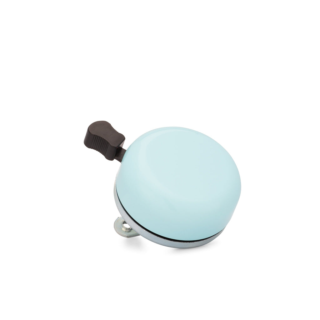 Classic bicycle bell color powder blue, corner view on white background. Vintage style bicycle bell.
